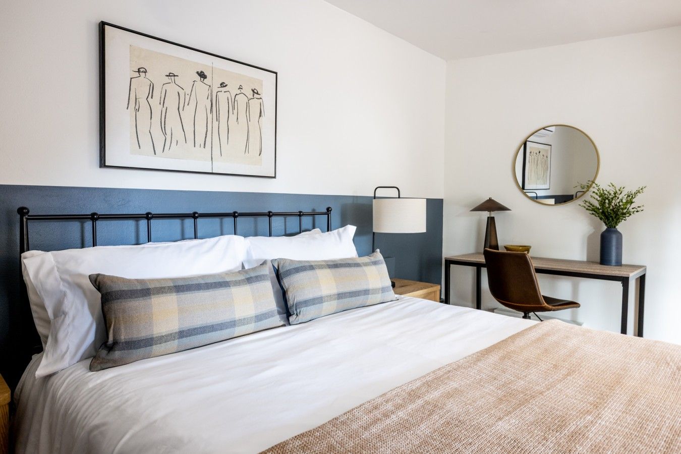 Bedroom with light walls and natural wood floors
