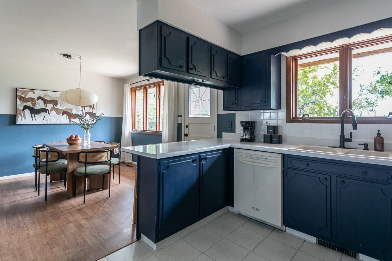 Kitchen with navy painted cabinets and sky blue wall